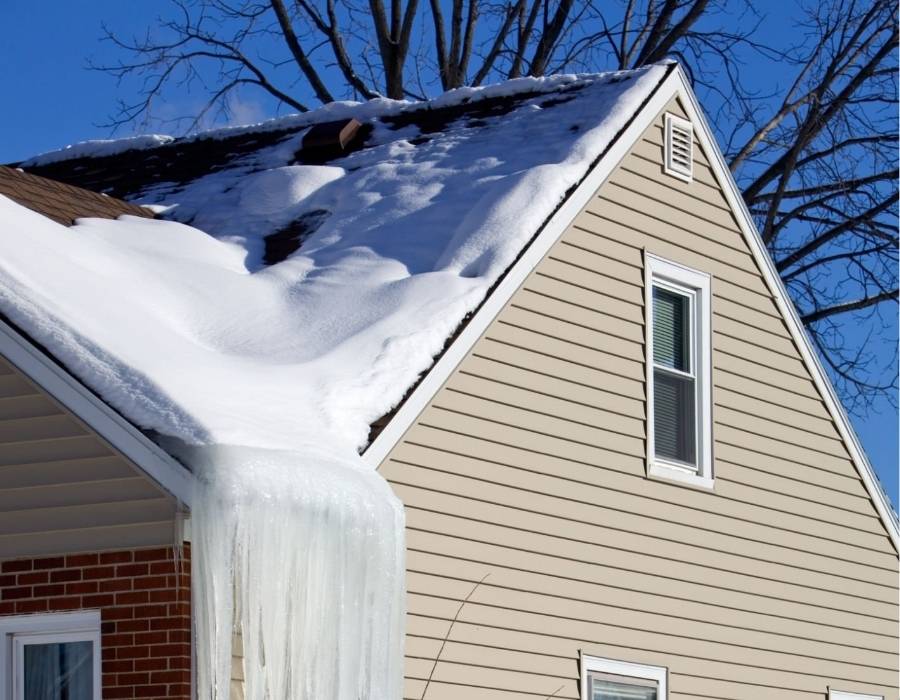 Ice dam and snow buildup on the roof of a Maryland home in winter